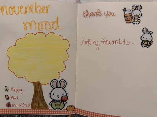 Customer's journal page featuring an Autumn Bunnies sticker on a hand-drawn November mood tree.