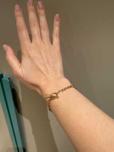 Customer's gold Cuban T Bar Bracelet worn on a hand.