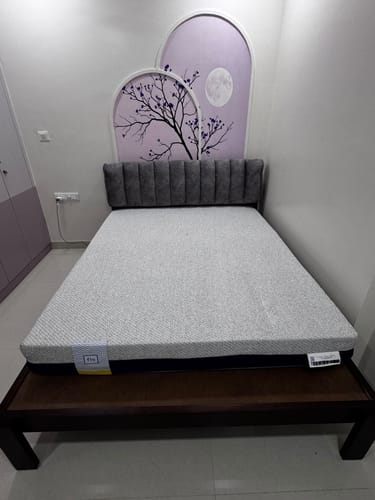 Customer's Flo Anti-Gravity Natural Latex Mattress placed on a dark wooden bed frame in a bedroom.