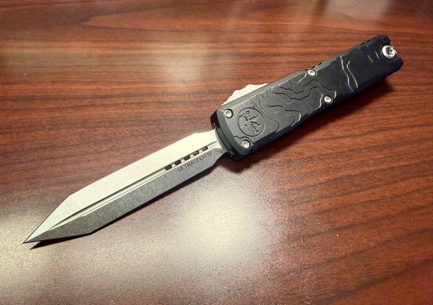 Customer photo review of Microtech Ultratech Spartan Gen IV 3.5" OTF – Topographic Black Deep Engraved, M390MK Stonewash – Made in USA (12234TP-10)