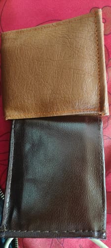 Customer's two leather-like wallets from the Spiderman wallet series, one tan and one dark brown, viewed from above.