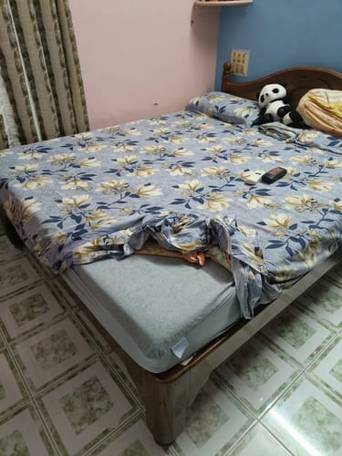 Customer's Flo Aloe Vera Gel Infused Waterproof Mattress Protector fitted on a bed with a floral patterned sheet