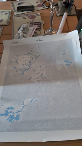 Customer's Dracula's mansion Paint by Number canvas laid out on a table with painting supplies nearby.