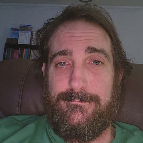 Reviewer's selfie, showing a person with a beard, looking relaxed and satisfied after using Fusion Gummies.