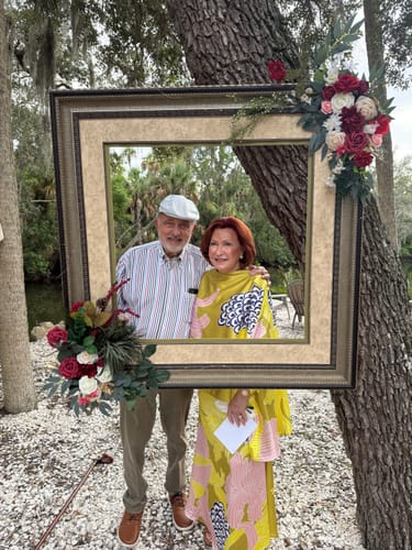 Customer's High Waisted Loose Flower Print Skirt in yellow, worn by a woman posing in a decorative picture frame.