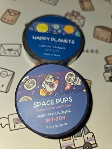Customer's two rolls of Blast Off Washi Tapes, featuring Space Pups and Happy Planets designs, on a patterned surface.