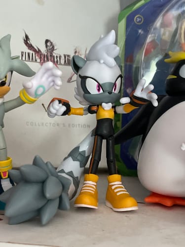Reviewer's Tangle the Lemur 4-inch action figure standing on a shelf next to other character figures.