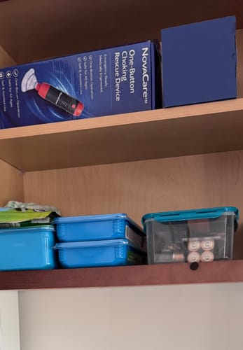 Customer's NovaCare Anti-Choking Device box on a shelf above kitchen containers