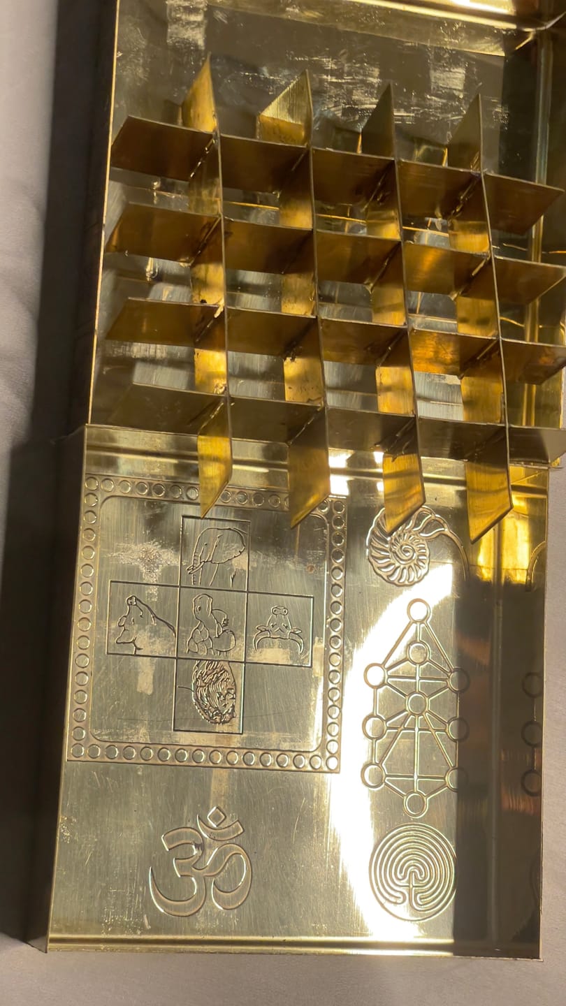 Customer photo review of Brass Manjusha Yantra Box with Partition – Vastu Remedy for Brahmasthan Correction | 16-Compartment Energy Organizer with 45 Devta Symbols | 5 & 9 Inch Sizes