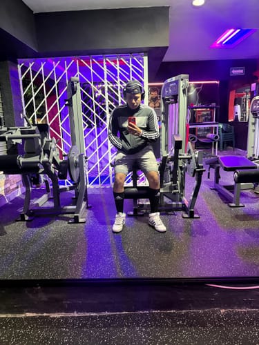 Customer's Testoplex-Enantato 300mg in use, reflected in a gym mirror while holding a phone.
