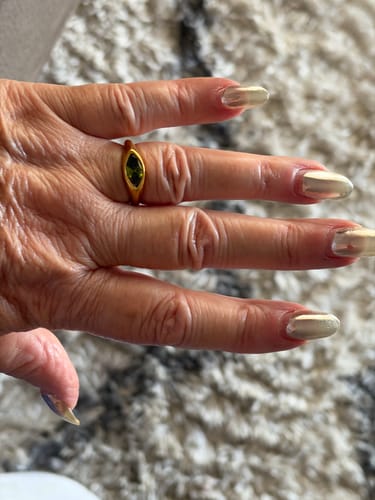 Customer's Green Arizona Crystal Ring on finger, featuring a gold band and a sleek green stone.