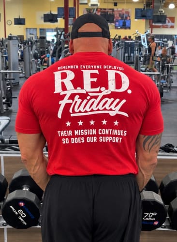 Customer's T.V.P. Elite Membership shirt in red, worn in a gym, showing back graphic with R.E.D. Friday text