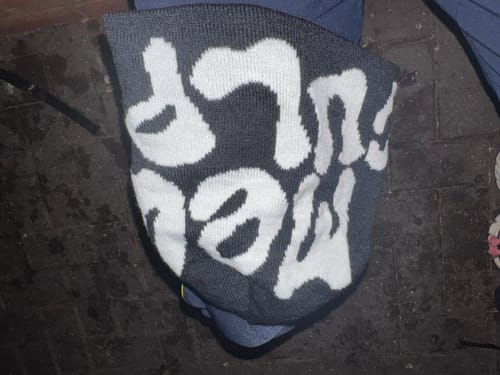 Reviewer's dark grey Bonnet Mea Culpa beanie with white graffiti-style lettering visible.