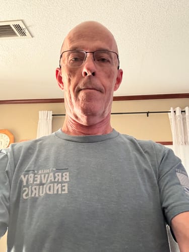 Customer's T.V.P. Elite Membership blue t-shirt with screen-printed white text worn by the reviewer.