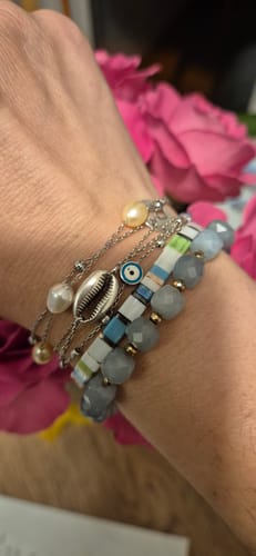 Customer's Silver Freshwater Pearl Layered Bracelet worn on a wrist alongside colorful stacked bead bracelets.