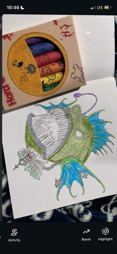 Customer's HJ Coloring Book Set with a colored angler fish illustration and a box of custom colorful crayons.