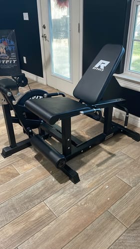 Customer's sturdy black RitFit Leg Extension Curl Machine assembled and standing on a light wood floor.