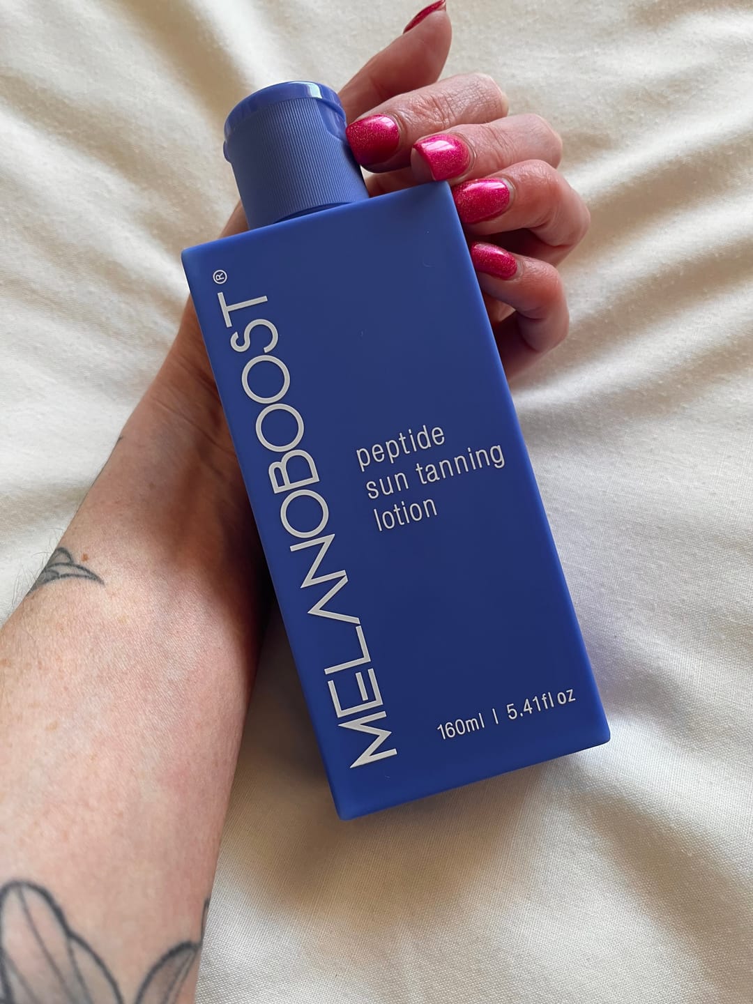 Customer photo review of Melanoboost Peptide Sun Tanning Lotion