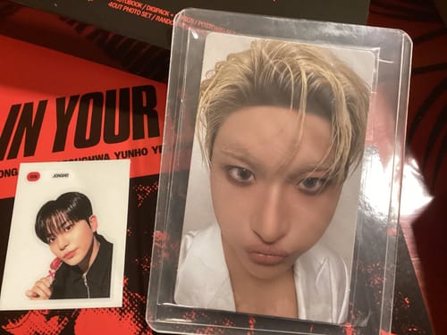 Customer's Ateez 2025 World Tour DVD, showcasing a blond-haired photo card in a protective sleeve and a small photo square.