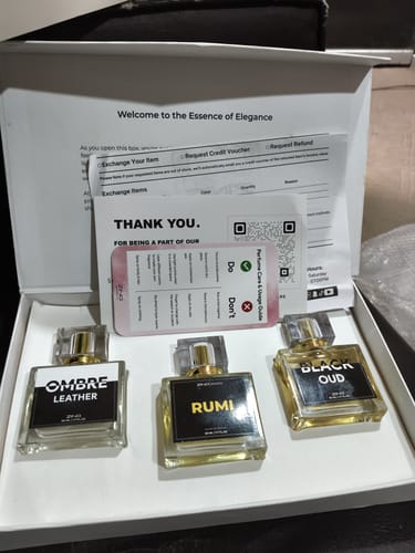 Customer's OUD Supreme Bundle set in an open white gift box with three perfume bottles and informational leaflets.