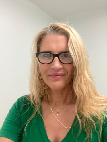 Customer's face showing results after using The Micro Infusion System, wearing a green shirt.
