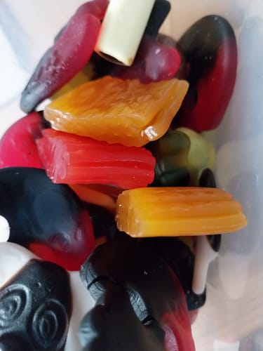 Customer's Discovery Liquorice Bundle featuring a variety of colorful, chewy, and firm liquorice shapes in a container.