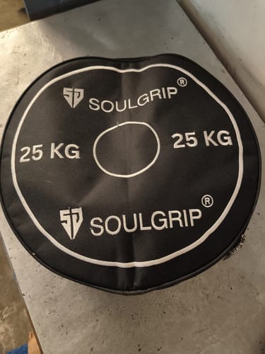 Customer's round black Belt-Mini Gym Bag with white Soulgrip branding and 25 kg weight design