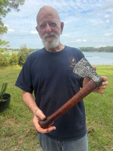 Customer's hand holding a finished metalworking project, likely smoothed with Flex Aluminum Oxide Sanding Belts.