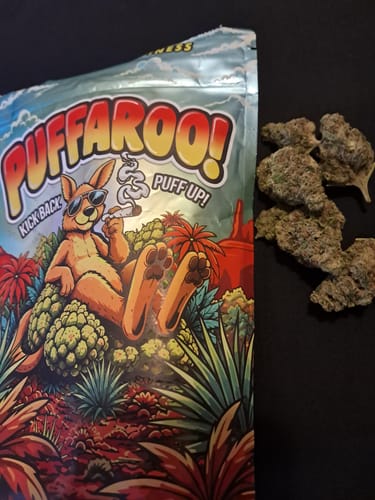 Customer's Puffaroo Maui Wowie bag next to small piles of dried cannabis flower buds.