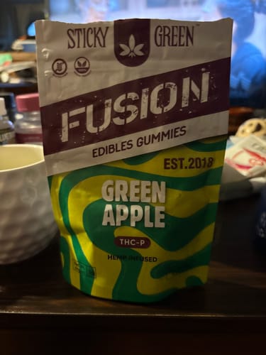 Customer's Green Apple Fusion Gummies pouch standing on a table surface