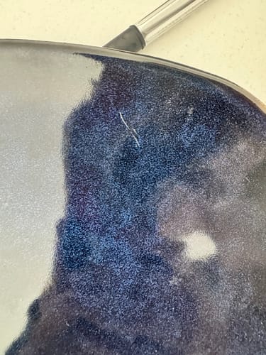 Customer's Ocean Blue dinner plate showing a prominent scratch on the glazed surface.