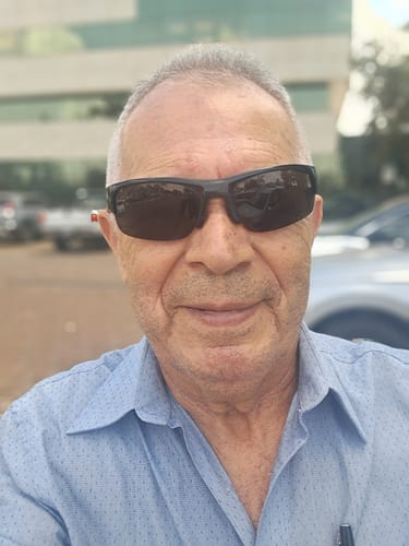 Reviewer's selfie wearing sunglasses, using the Attracione Men perfume.