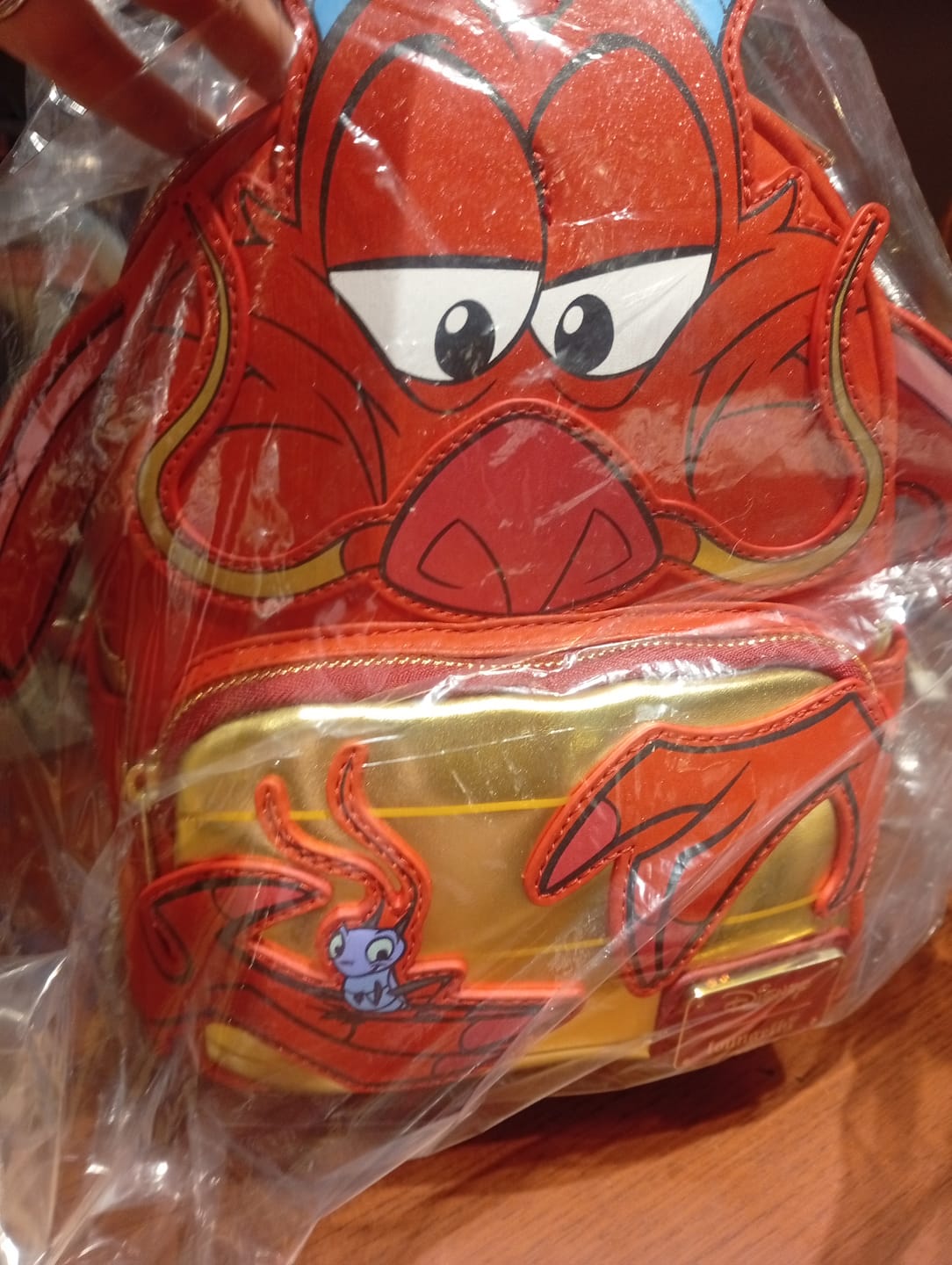 Customer photo review of Loungefly Disney Mulan Mushu Glitter Cosplay Mini Backpack