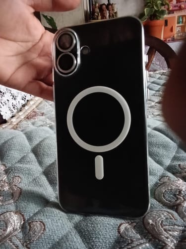 Customer's black phone case with a circular magnetic ring, held in a person's hand.