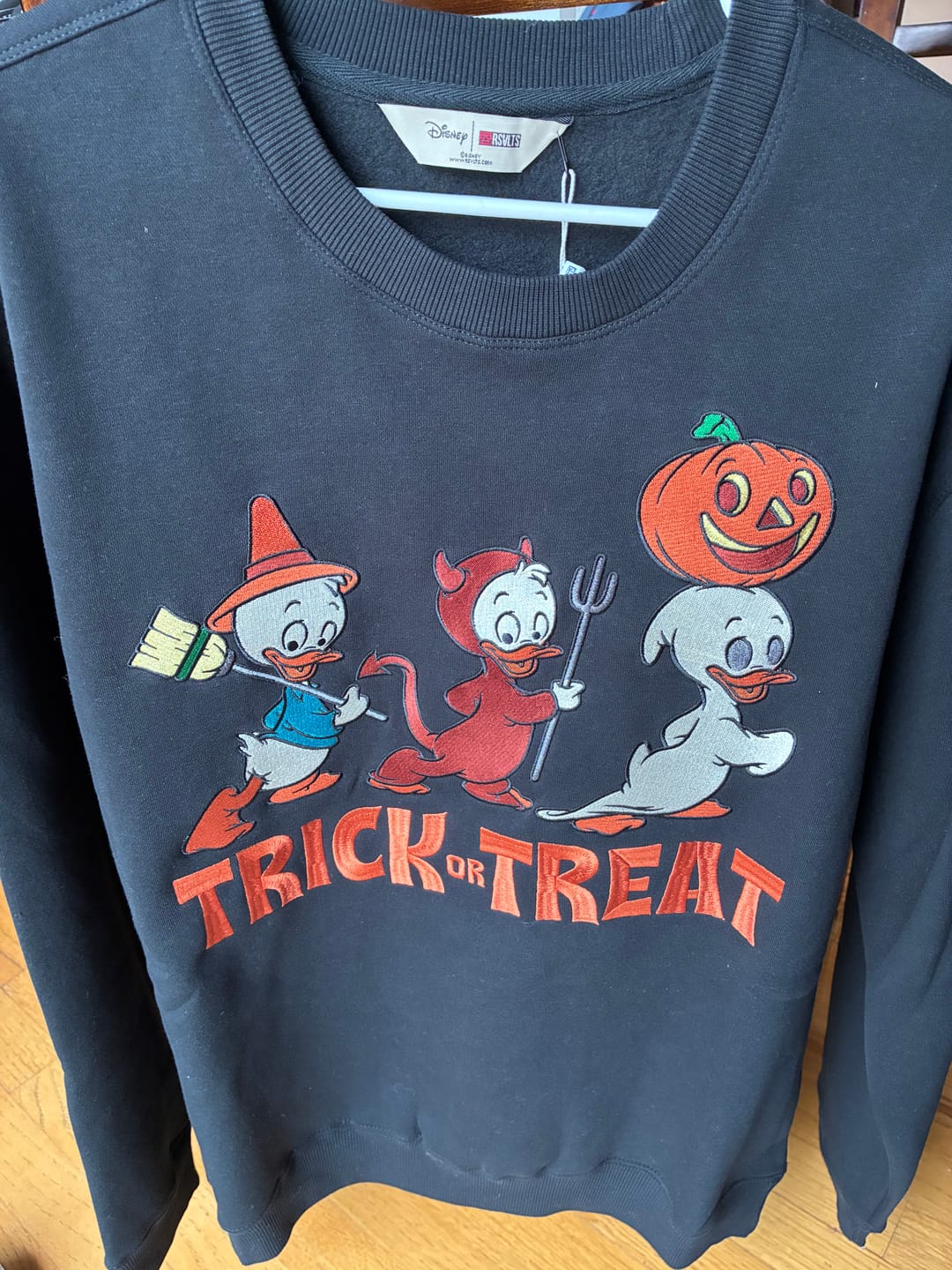 Customer photo review of Disney "Tricks, Treats, and Trouble" – Crewneck Sweatshirt