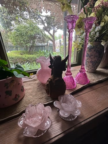 Customer's Miss Angelique Fairy Statue nestled on a wooden windowsill among decorative glassware and a small plant.