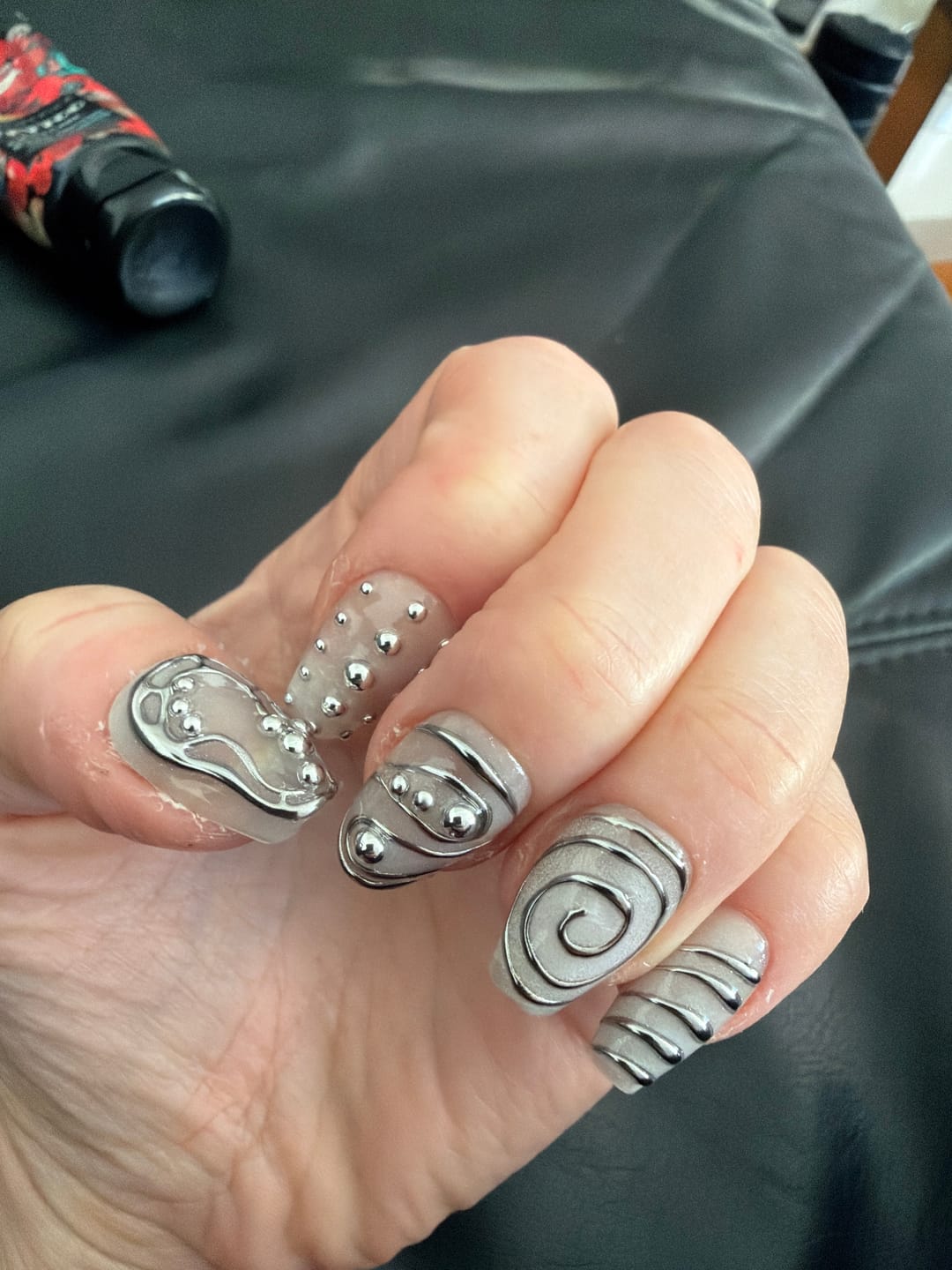 Customer photo review of Silver Chrome Y2K Press-On Nails – 3D Metallic Spiral Futuristic Fake Nails