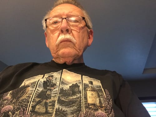 Customer's Scotland Panels T-Shirt, a black vintage-style tee showing highland, bagpipe, castle, and whisky graphics.