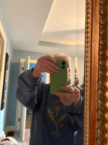 Customer's mirror selfie wearing the blue Cluaran Thistle Sweatshirt with botanical print