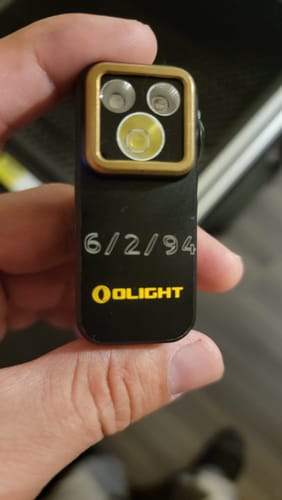Customer's AtomStack Swift laser engraver, close-up showing custom etched date on black component.