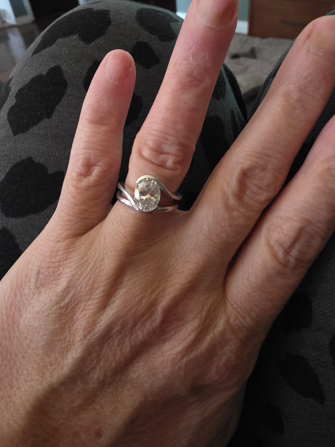 Customer photo review of Minimalist Half-Bezel Solitaire Bypass Oval Cut Moissanite Engagement Ring