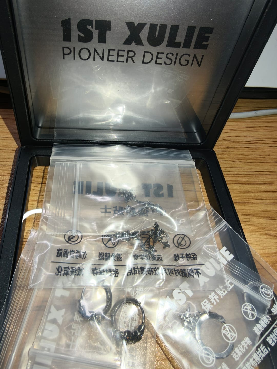Customer photo review of "Irises" 925 Sterling Silver Gothic Oxidized Dangle Cross Earrings