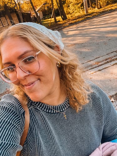 Customer's Valentina Gold Hoop Earrings worn by a person outdoors in sunlight.
