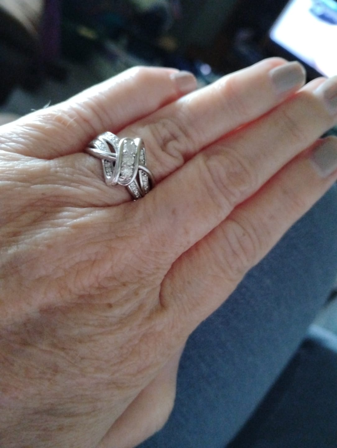 Customer photo review of Swirl Interlocking Criss-Cross Moissanite Wedding Band Ring
