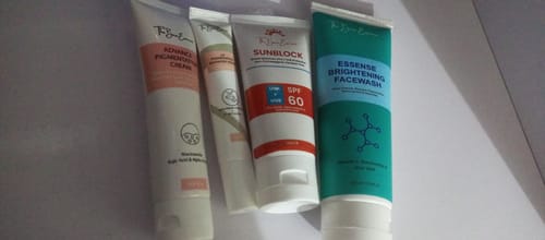 Customer's All Glow Pigmentation Bundle, including four skincare tubes aligned on a flat surface.