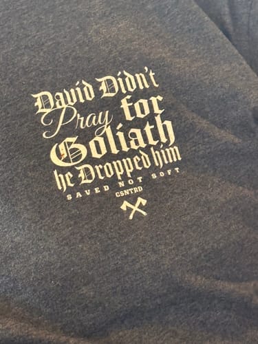 Customer's David Didn’t Pray for Goliath T-Shirt in dark grey, featuring the inspirational text graphic in white.