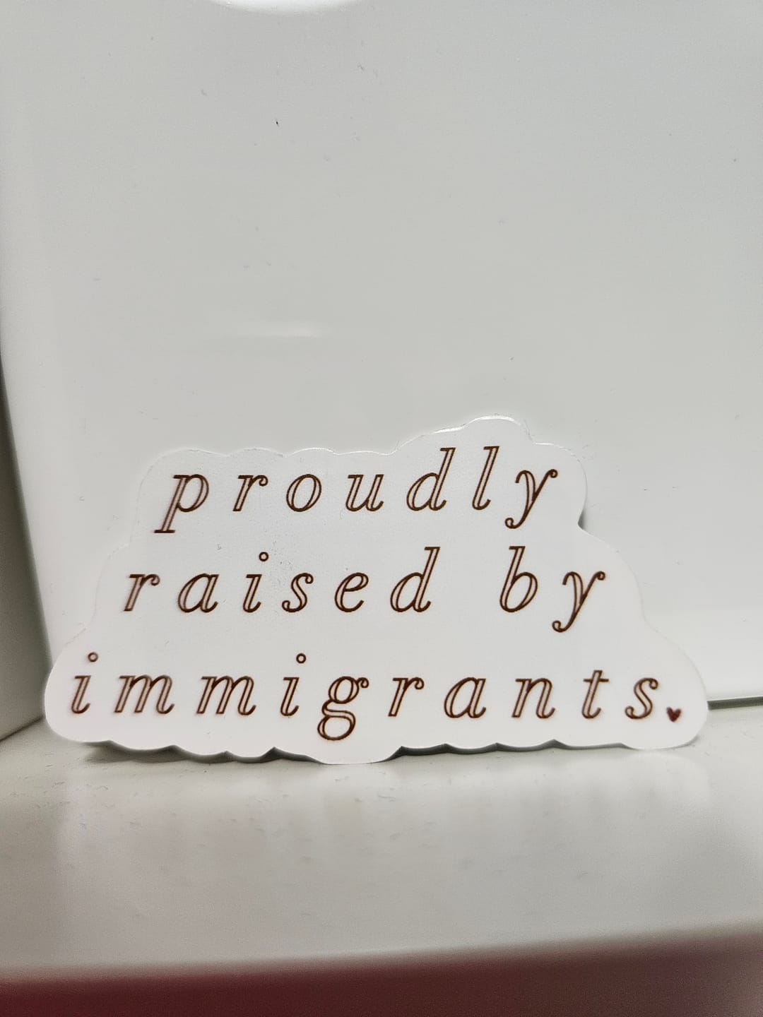 Customer photo review of 'Proudly Raised By Immigrants' Sticker