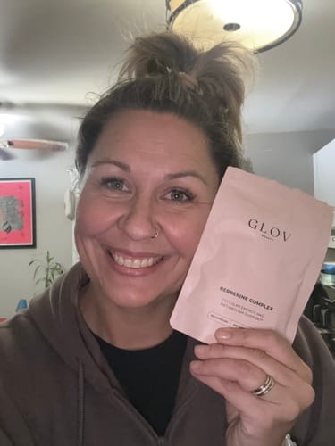 Smiling customer holding her GLOV Berberine Complex, customer photo