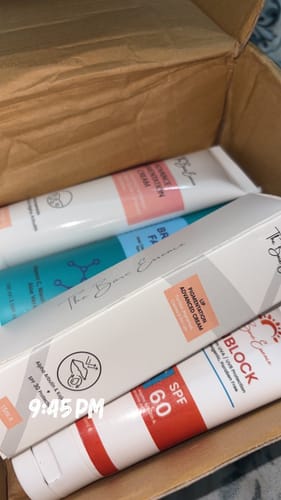 Customer's box containing the All Glow Pigmentation Bundle including facial wash, creams, and SPF 60 sunblock.