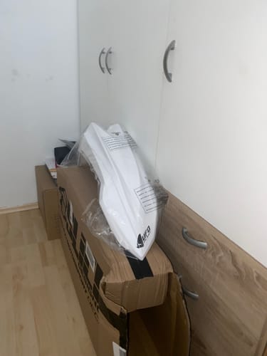 Customer's white Beta RR Enduro front fender, still sealed in protective plastic packaging inside a cardboard box.